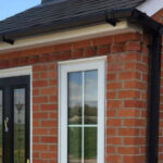 how to attach a porch roof to a brick house